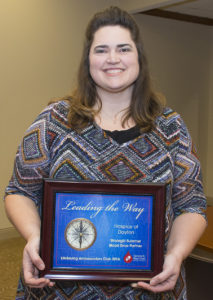 Melisha holding a Leading the Way plaque recognizing Ohio's Hospice of Dayton as a leader in blood donations.
