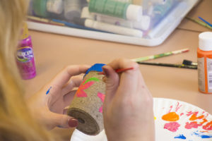 Friend joining Madison Dox on her 18th Birthday painting pottery in honor of Madison's grandfather.