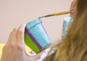 Friend joining Madison Dox on her 18th Birthday painting pottery in honor of Madison's grandfather.