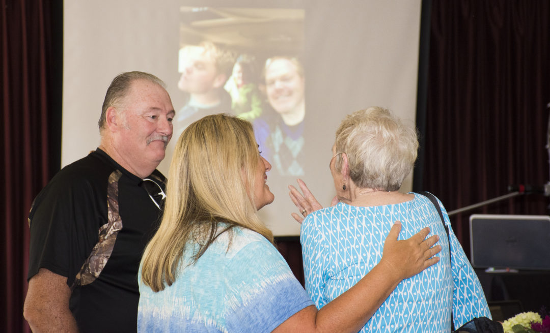 Mary and friends enjoy looking at a slideshow of her favorite memories at her Big A-Wake.